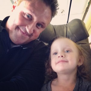 Daddy and Ava on plane ready to fly