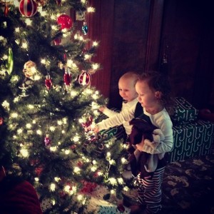 Ava and Charlie sitting by the tree