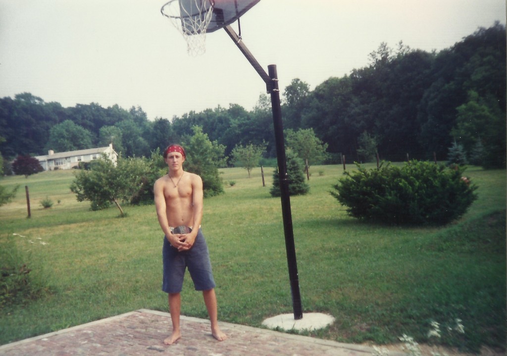 Adrian holding basketball in high school