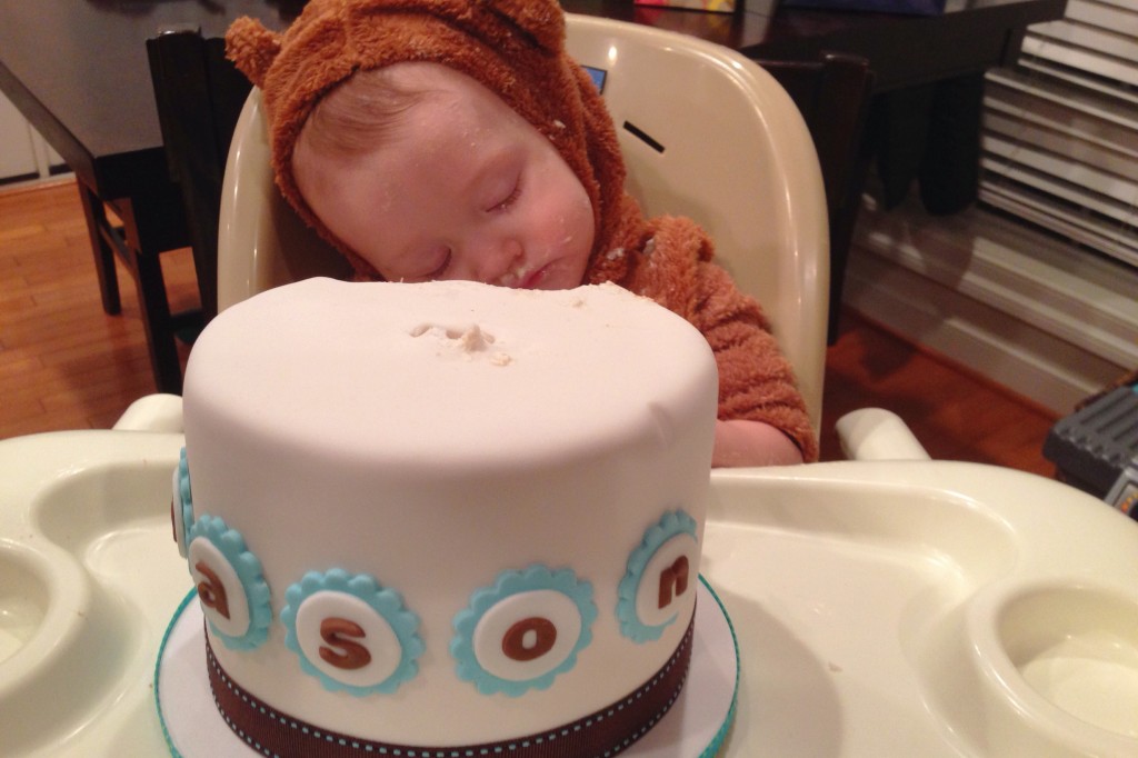 Mason asleep on his cake