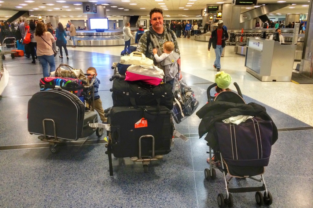 Dad pushes luggage through DFW airport