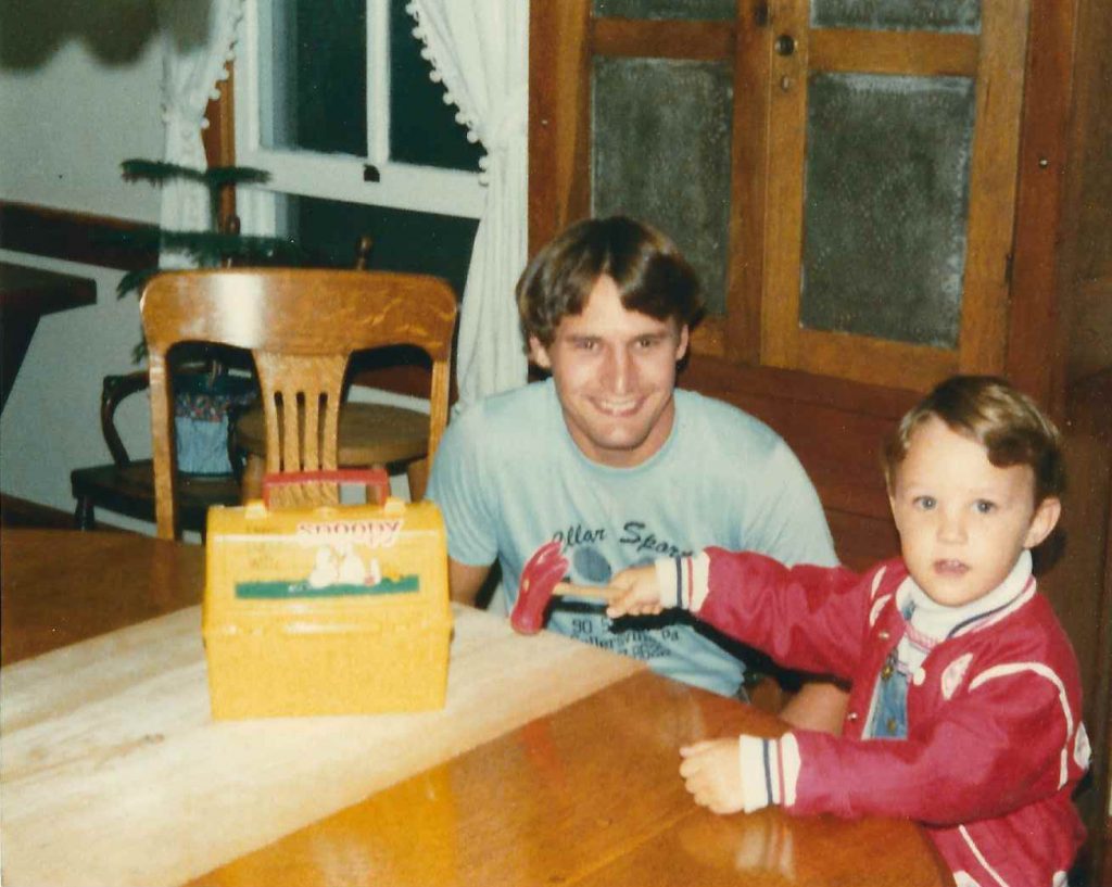 Dad and Adrian at table as a kid